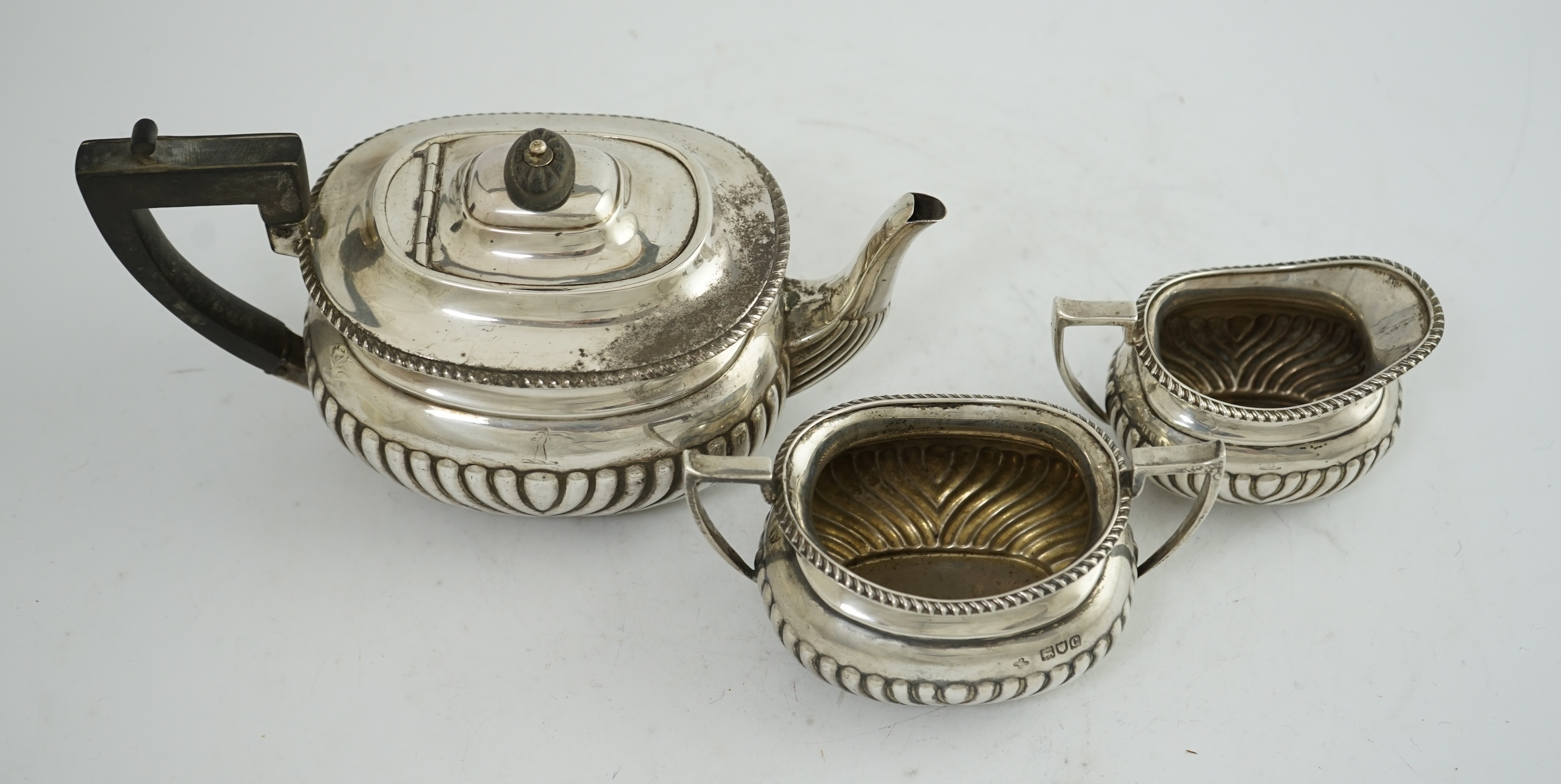 A late Victorian demi-fluted silver three piece tea set, by Horace Woodward & Co Ltd